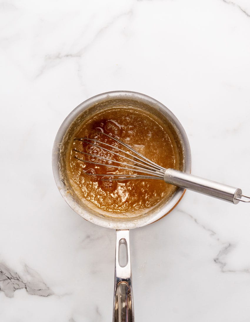 homemade caramel sauce in a small metal pot