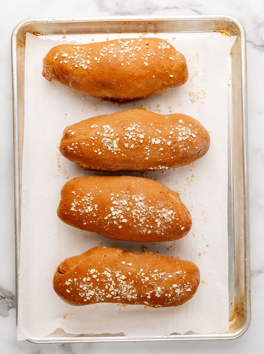 baked loaves of restaurant style brown bread on a parchment paper lined baking pan