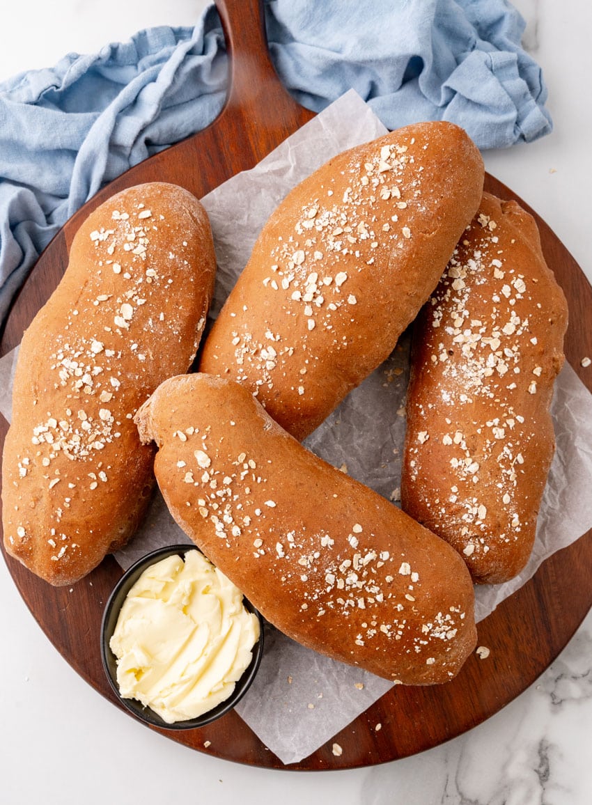 fresh loaves of copycat cheesecake factory brown bread on a wooden serving tray