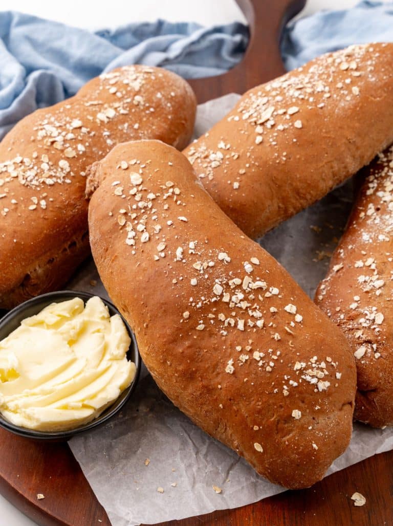 fresh loaves of copycat cheesecake factory brown bread on a wooden serving tray