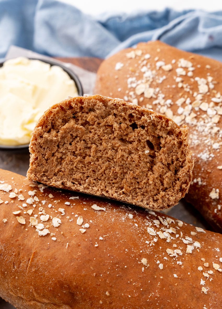 fresh loaves of copycat cheesecake factory brown bread on a wooden serving tray