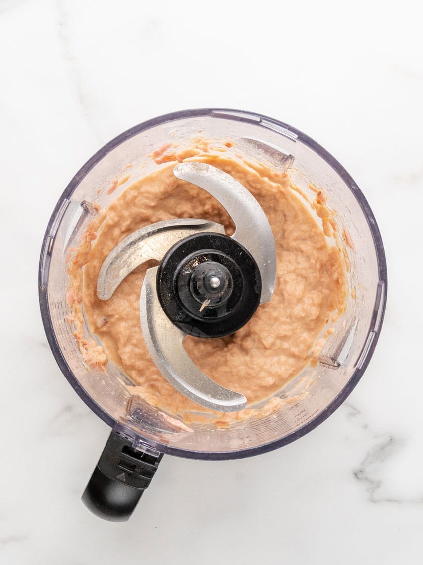canned salmon, eggs, and oil blended together in the bowl of a food processor