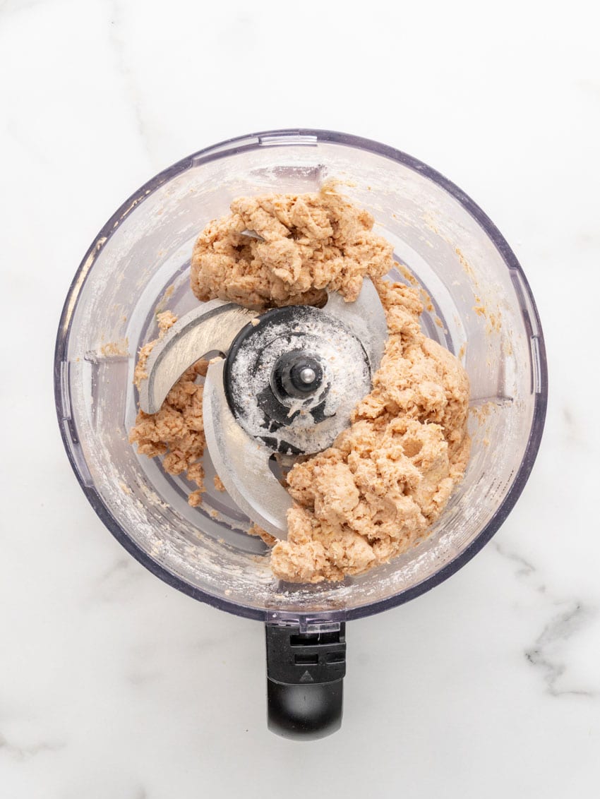 homemade cat treat batter in the bowl of a food processor
