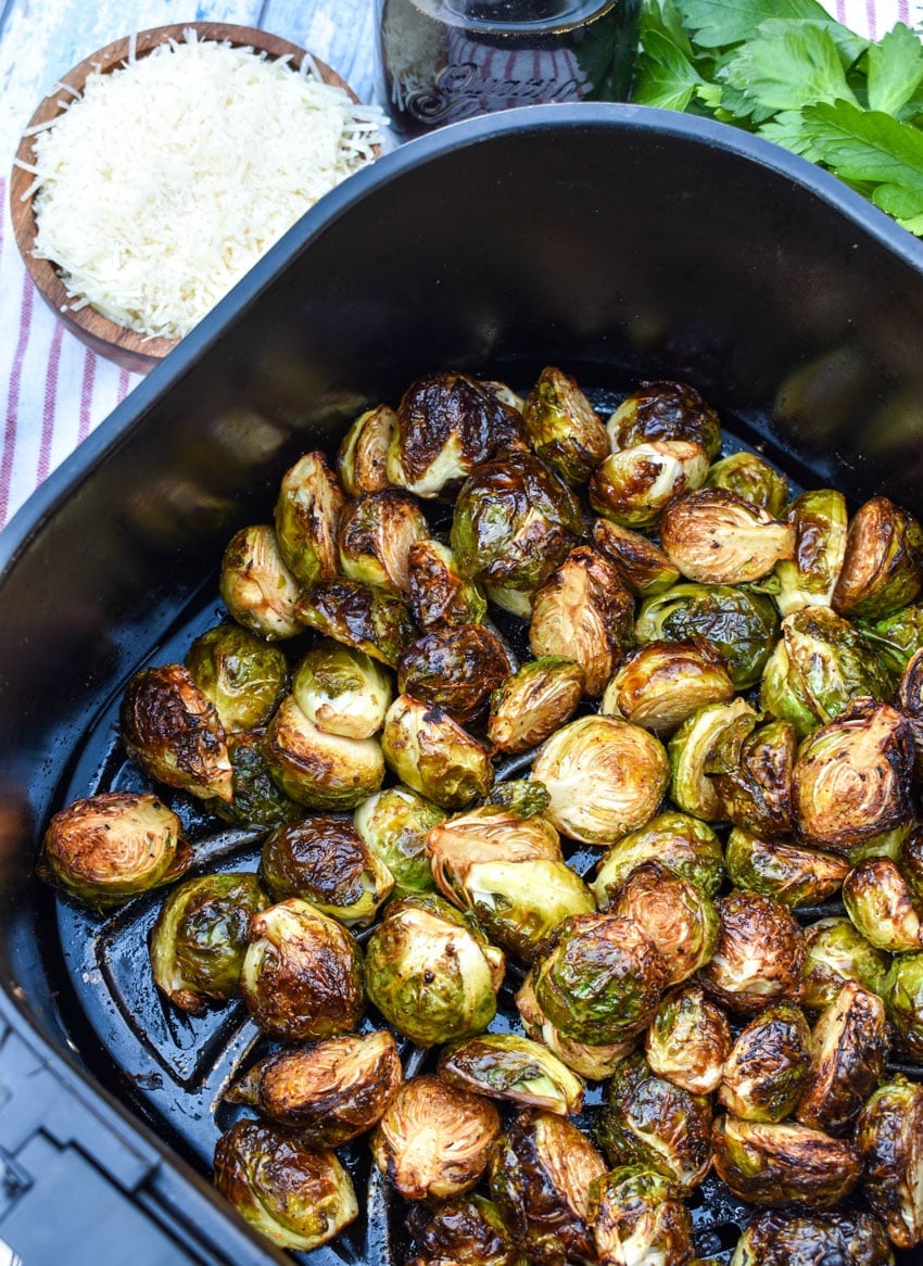 balsamic glazed roasted brussels sprouts in the basket of an air fryer