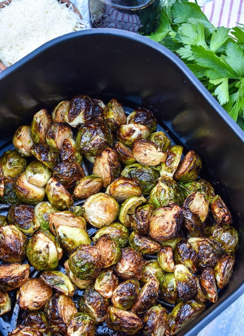 balsamic glazed roasted brussels sprouts in the basket of an air fryer