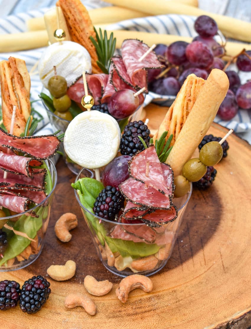 homemade charcuterie cups on a wooden serving board