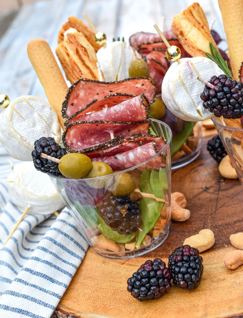 homemade charcuterie cups on a wooden serving board