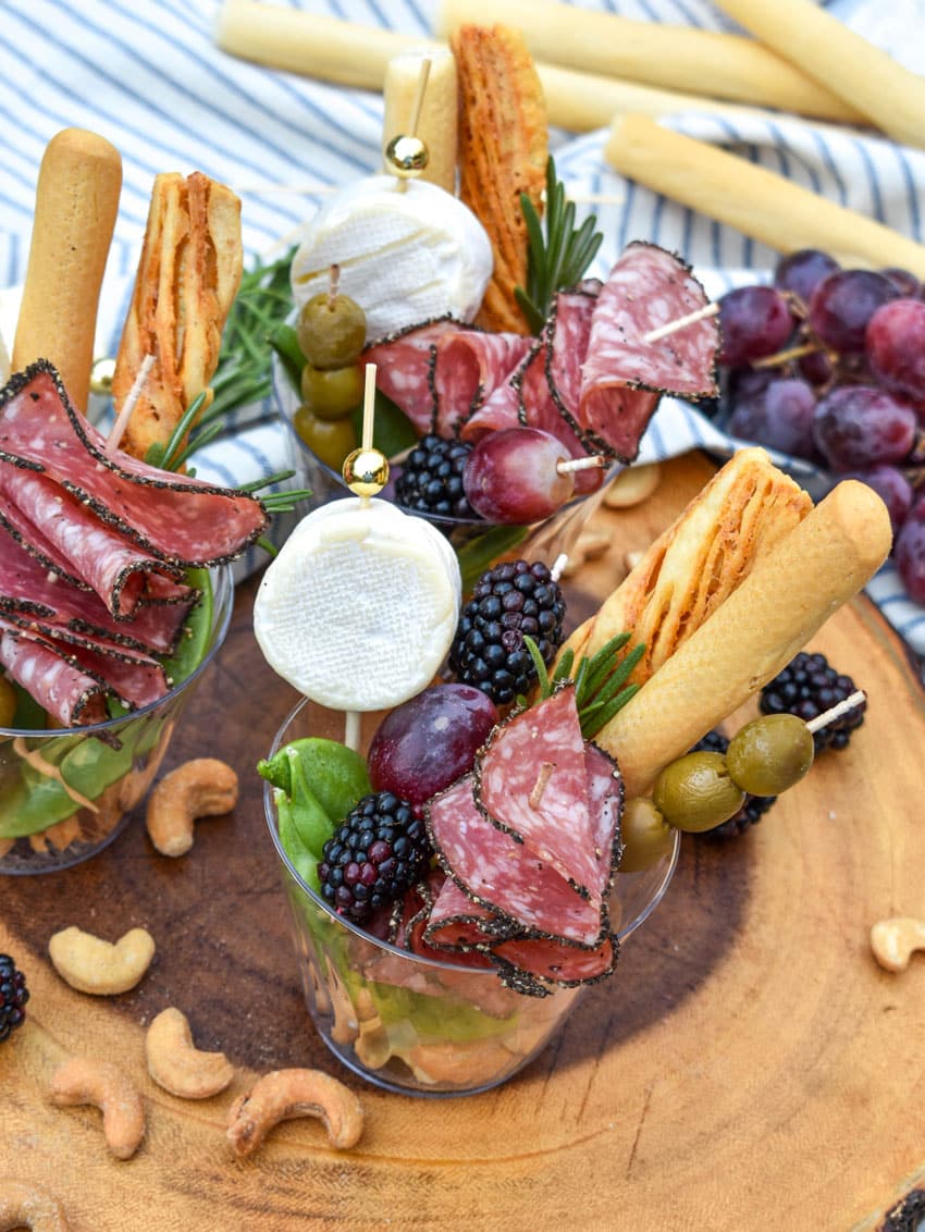 homemade charcuterie cups on a wooden serving board