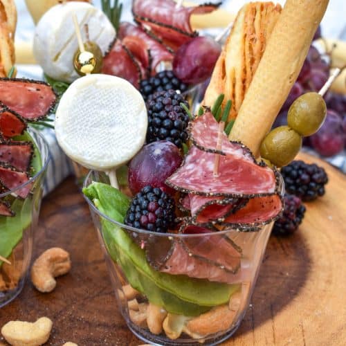 homemade charcuterie cups on a wooden serving board