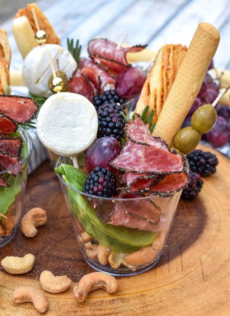 homemade charcuterie cups on a wooden serving board