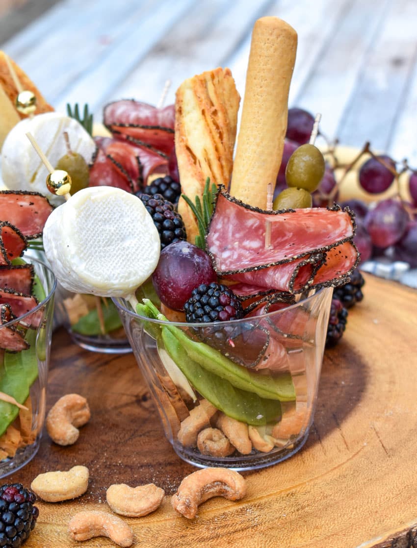 homemade charcuterie cups on a wooden serving board