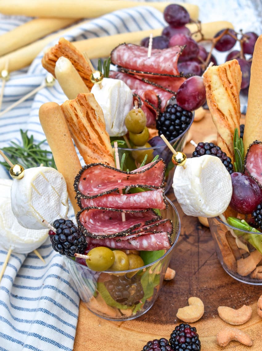 homemade charcuterie cups on a wooden serving board