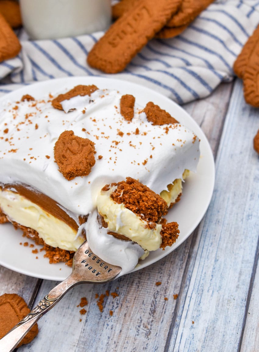 a slice of cookie butter delight layered dessert on a small white plate