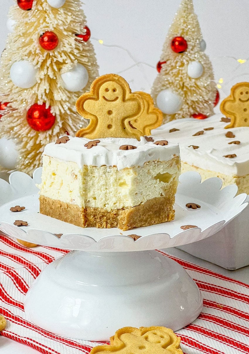 a close up of a bitten gingerbread cheesecake bar