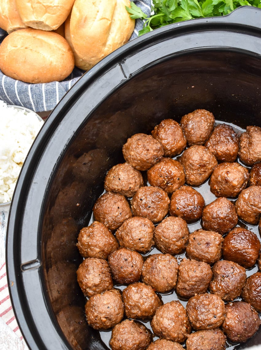 brown sugar meatballs in the black bowl of a slow cooker