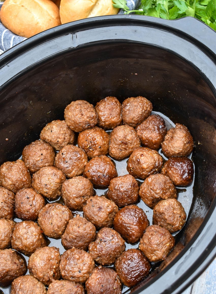 brown sugar meatballs in the black bowl of a slow cooker