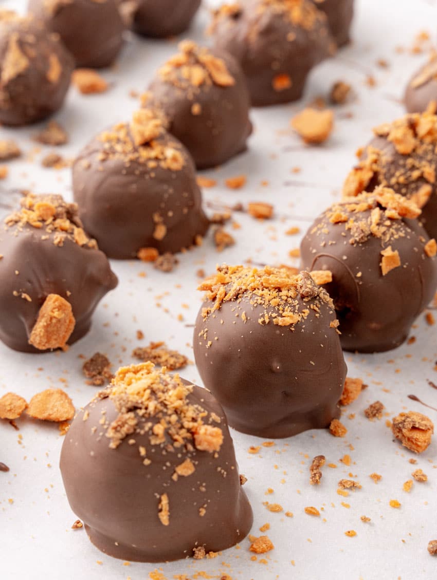 homemade butterfinger truffles on white parchment paper