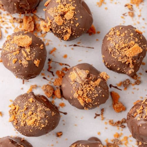 homemade butterfinger truffles on white parchment paper