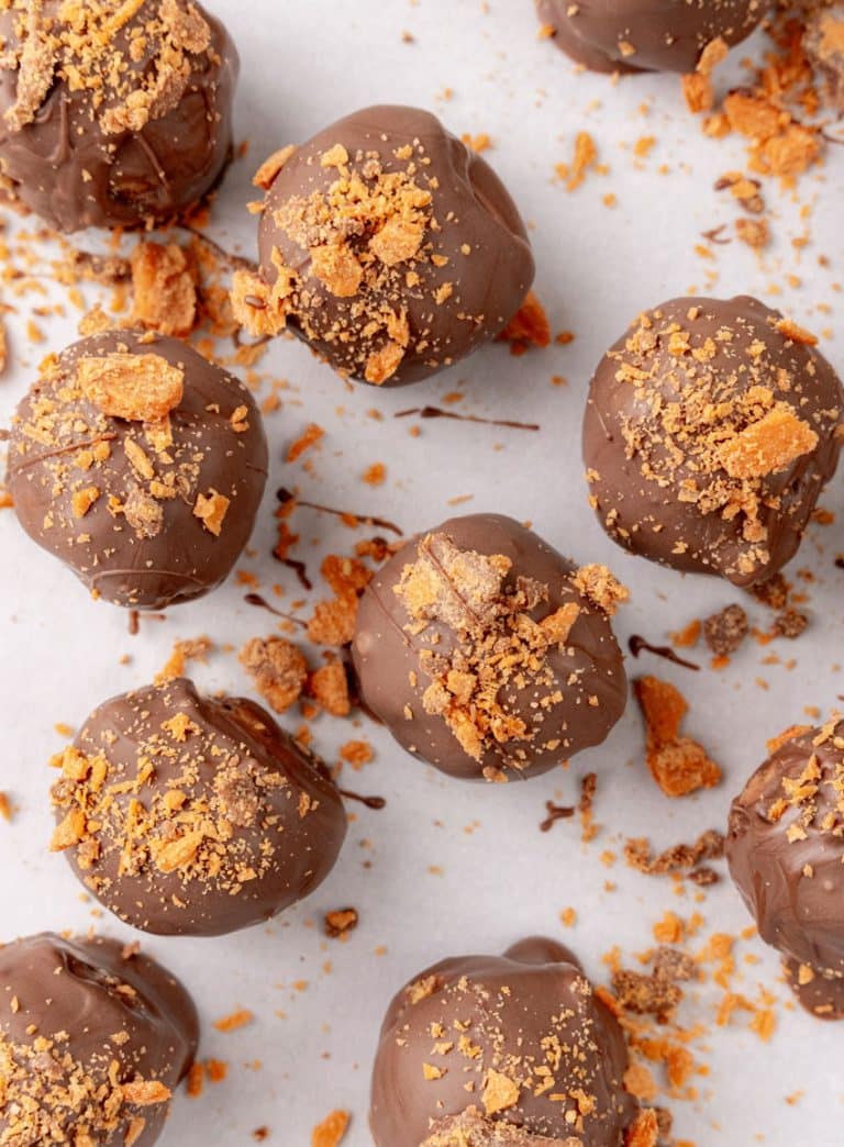 homemade butterfinger truffles on white parchment paper