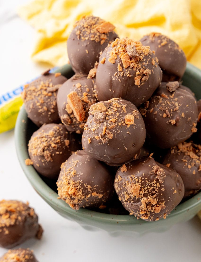butterfinger truffles piled in a green bowl