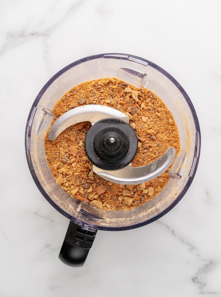 crushed graham crackers and butterfinger candies in the bowl of a food processor fitted with the blade attachment