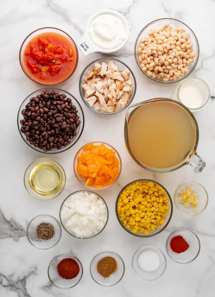 an overhead image showing the measured ingredients needed to make a homemade batch of copycat chick fil a chicken tortilla soup