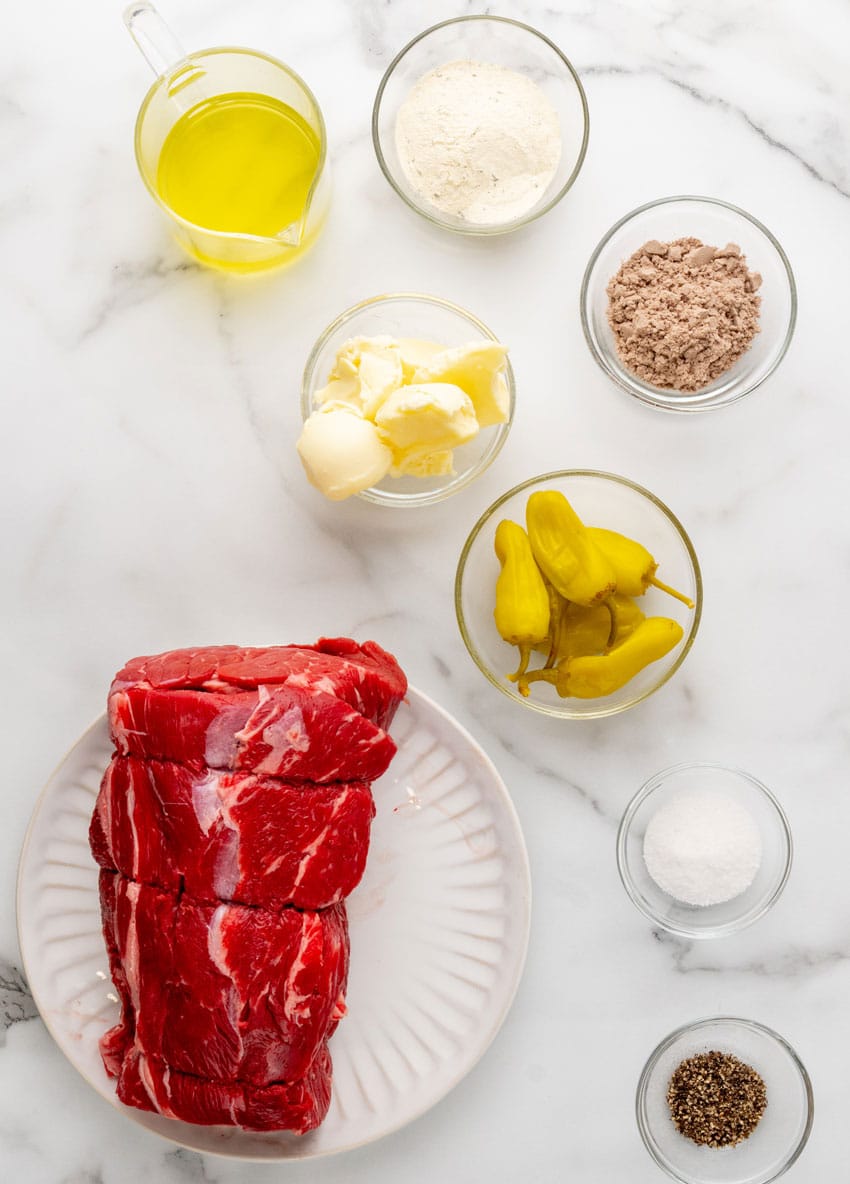 an overhead image showing the measured ingredients needed to make a homemade mississippi pot roast in the slow cooker