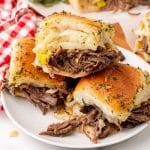 three mississippi pot roast sliders stacked on a small white plate