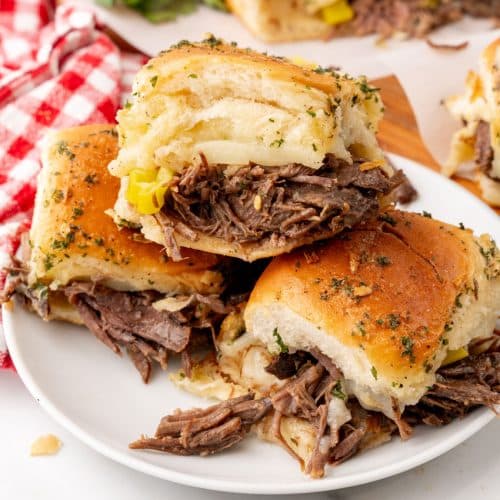 three mississippi pot roast sliders stacked on a small white plate