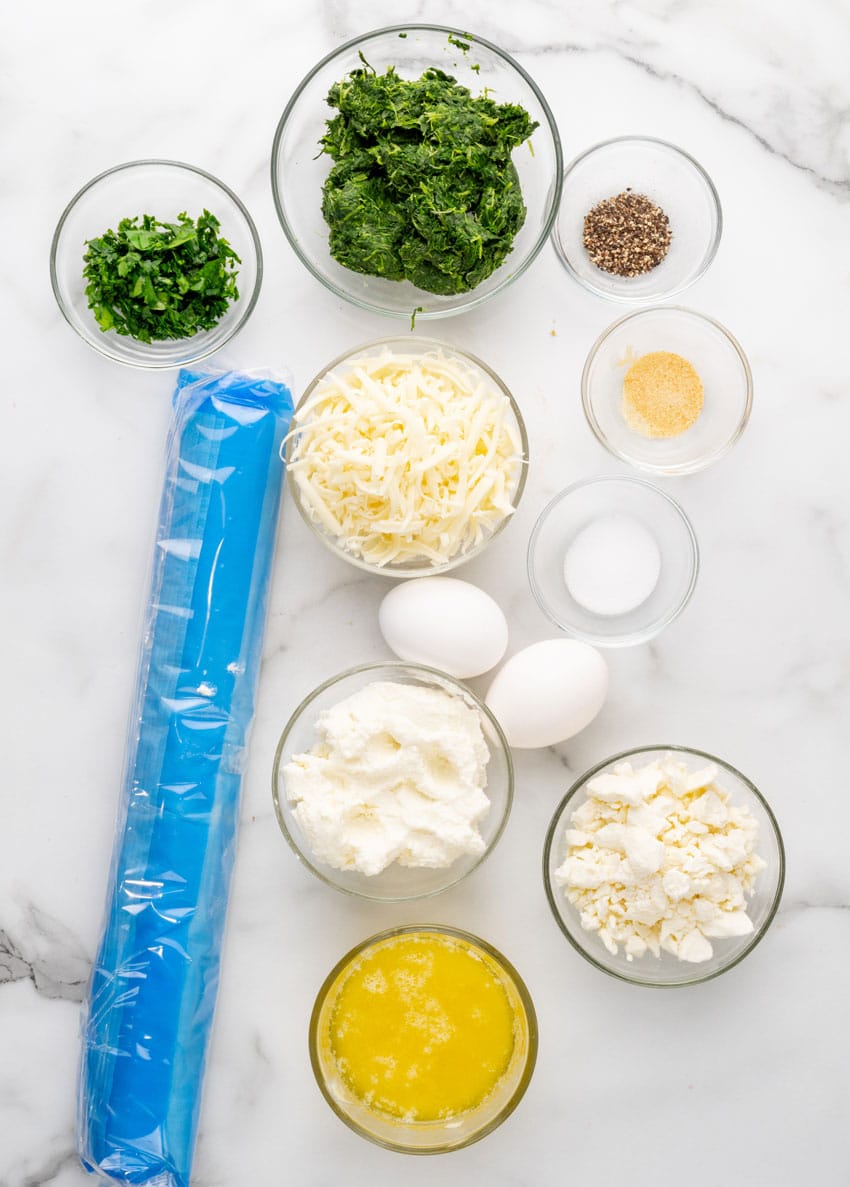 an overhead image showing the measured ingredients needed to make a batch of homemade spanakopita
